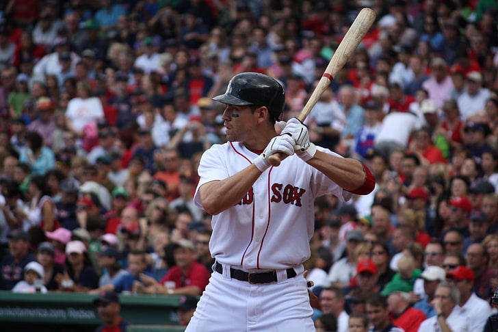 MLB minimum salary 2024 a man with a bat prepares to hit the ball